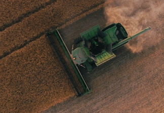 Foto de máquina agrícola em meio a lavoura.