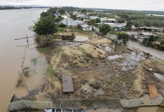 Foto de área alagada com casas ao redor. Foto de área alagada com casas ao redor.