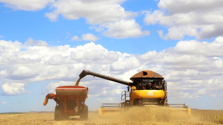 Máquina colhendo e depositando seus produtos no reservatório Máquina colhendo e depositando seus produtos no reservatório