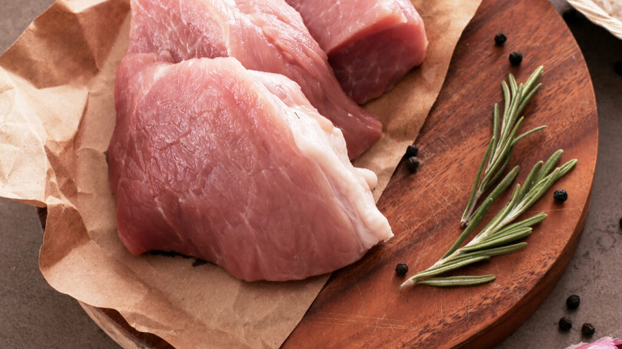 carne de suíno crua, em cima de uma tábua carne de suíno crua, em cima de uma tábua