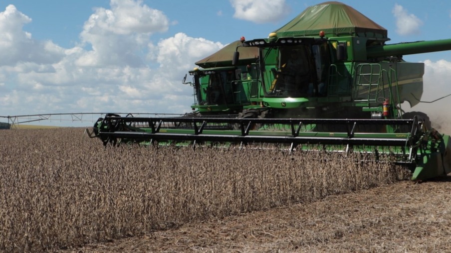 Foto de colheitadeira verde em lavoura de soja. Foto de colheitadeira verde em lavoura de soja.