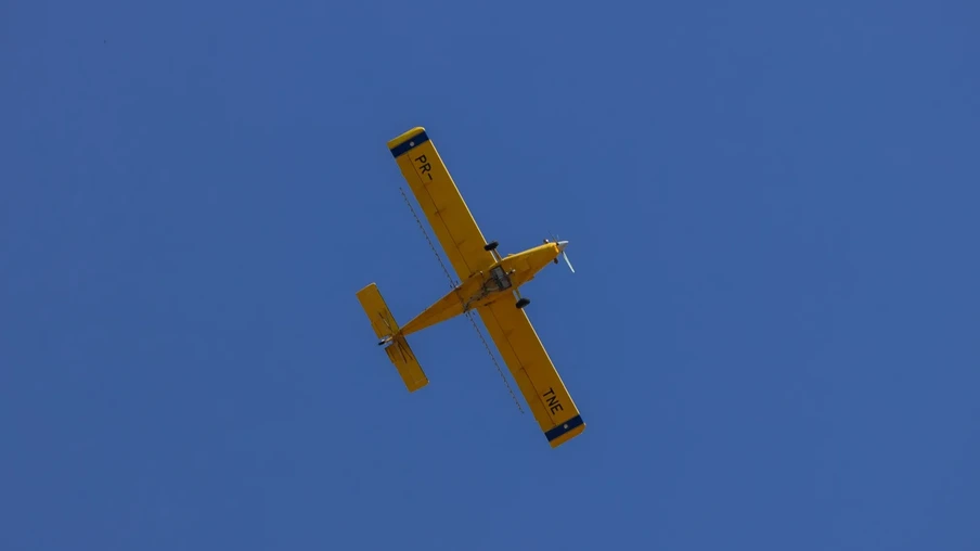Foto de avião agrícola amarelo voando. Foto de avião agrícola amarelo voando.