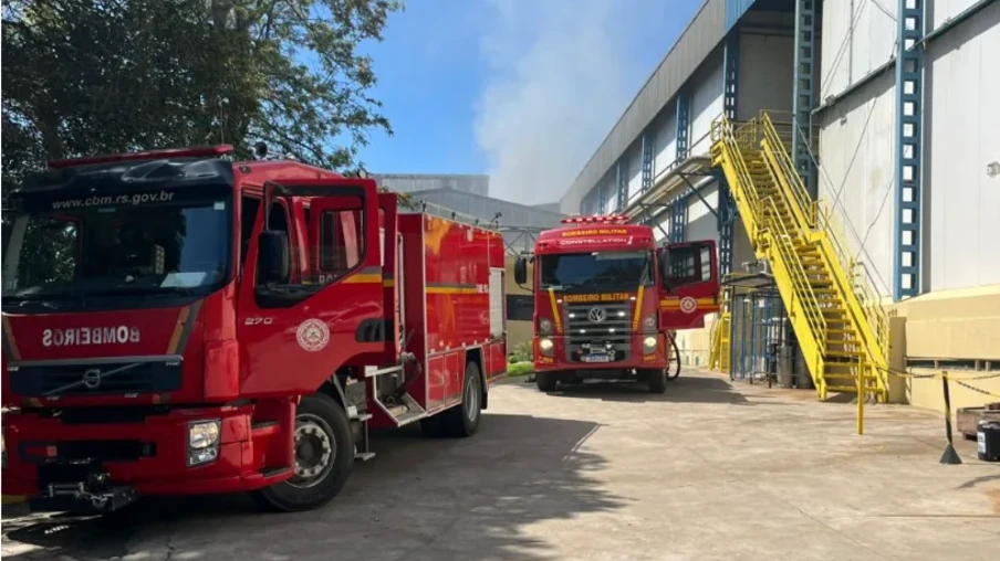 Foto de caminhões de bombeiros perto de unidade industrial e de fumaça. Foto de caminhões de bombeiros perto de unidade industrial e de fumaça.